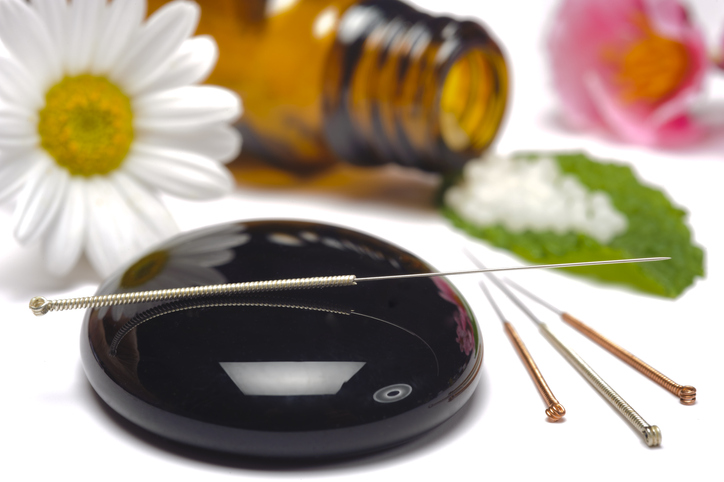 alternative medicine with herbal pills and acupuncture